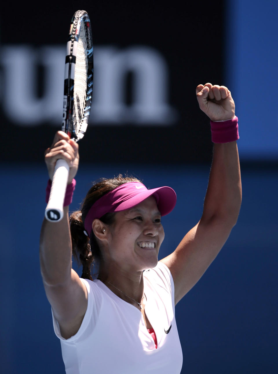 Li Na of China celebrates after defeating Eugenie Bouchard of Canada during their semifinal at the Australian Open tennis championship in Melbourne, Australia, Thursday, Jan. 23, 2014.(AP Photo/Rick Rycroft)