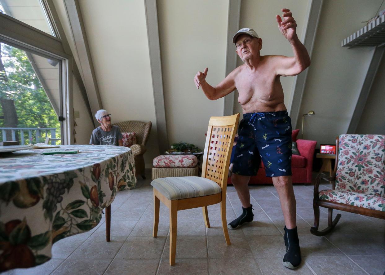 George Klimowicz, 89, dances during an interview on Wednesday, July 27, 2022, at Sunset Lake in New Hope, Wis. Klimowicz, who has been diagnosed with Alzheimer's, swims across the lake every day from May through October or until the water gets too cold.