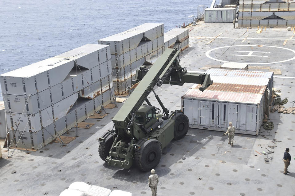 This undated photo released early Tuesday, April 30, 2024, by the U.S. military's Central Command shows construction off a floating pier in the Mediterranean Sea off the Gaza Strip. A U.S. Navy ship involved in the American-led effort to bring more aid into the besieged Gaza Strip is off shore from the enclave, slowly building out a floating platform for the operation, satellite photos analyzed Monday, April 29, 2024, by The Associated Press show. (U.S. military's Central Command via AP)