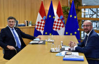 European Council President Charles Michel, right, poses for a photographer with Croatia's Prime Minister Andrej Plenkovic, ahead of a meeting on the sidelines of an EU summit at the European Council building in Brussels, Thursday, Oct. 1, 2020. European Union leaders are meeting to address a series of foreign affairs issues ranging from Belarus to Turkey and tensions in the eastern Mediterranean. (John Thys, Pool via AP)