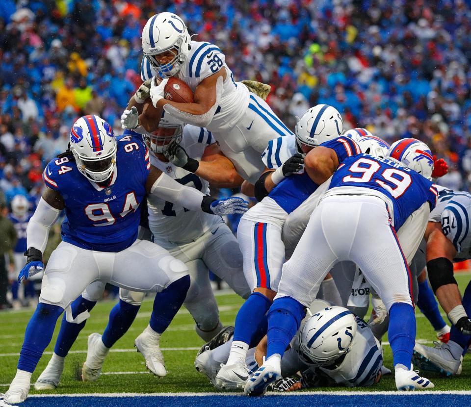 Jonathan Taylor leaps over Bills players for a touchdown in the second quarter.