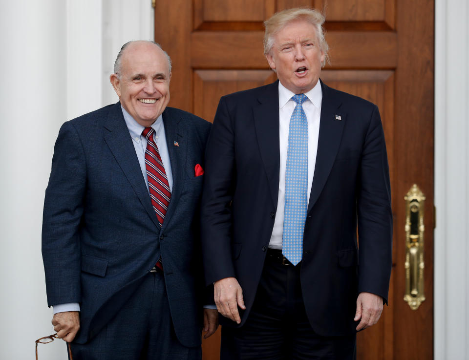 Donald Trump, right, and former New York Mayor Rudy Giuliani pose for photographs as Giuliani arrives at the Trump National Golf Club Bedminster clubhouse in Bedminster, N.J. Giuliani is joining the legal team defending President Donald Trump in the special counsel’s Russia investigation. That’s according to a statement from Trump personal attorney Jay Sekulow. (AP Photo/Carolyn Kaster)