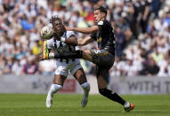 West Bromwich Albion's Brandon Thomas-Asante, left, and Southampton's Jan Bednarek battle for the ball during the EFL Championship play-off, semi-final, first leg match at The Hawthorns, West Bromwich, England, Sunday May 12, 2024. (Jacob King/PA via AP)
