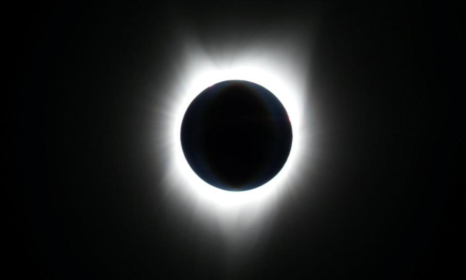 The sun is obscured by the moon during a solar eclipse as seen from an Alaska Airlines commercial jet over the Pacific Ocean.