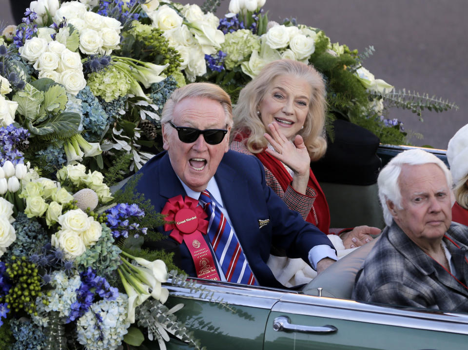 Veteran Los Angeles Dodgers broadcaster and parade grand marshal Vin Scully and his wife, Sandi, ride in the Rose Parade in Pasadena, Calif., Wednesday, Jan. 1, 2014. (AP Photo/Reed Saxon)