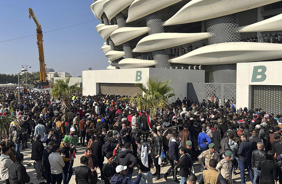 Iraqi football fans try to enter the Basra International Stadium in Basra, Iraq, Thursday, Jan 19, 2023. A stampede outside the stadium has killed and injured a number of people. (AP Photo/Anmar Khalil)