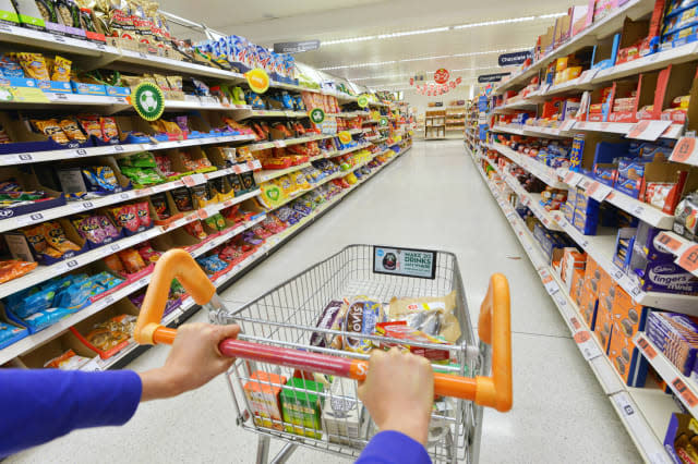 LONDON - JULY 3: View of a shopping trolley and aisle at a Sainsbury's supermarket on July 3, 2014 in London, UK. Sainsbury's is