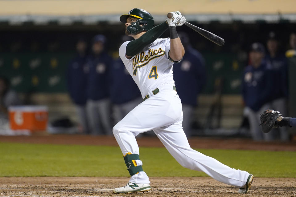 Oakland Athletics' Chad Pinder hits a grand slam home run against the Houston Astros during the seventh inning of a baseball game in Oakland, Calif., Friday, Sept. 24, 2021. (AP Photo/Jeff Chiu)