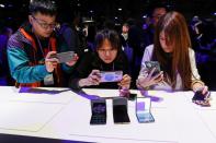 Attendees take photographs of the new Samsung Galaxy Z Flip foldable smartphone during Samsung Galaxy Unpacked 2020 in San Francisco