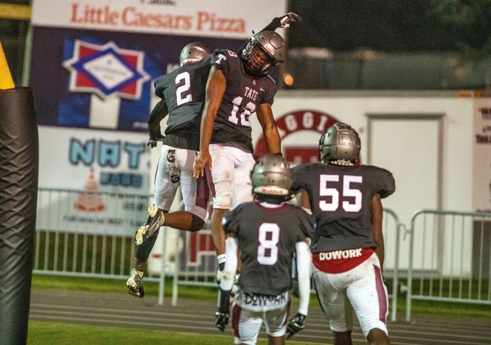 Tate's Andre Colston celebrates a touchdown as they take on Navarre at Tate High School Friday, September 16, 2022.