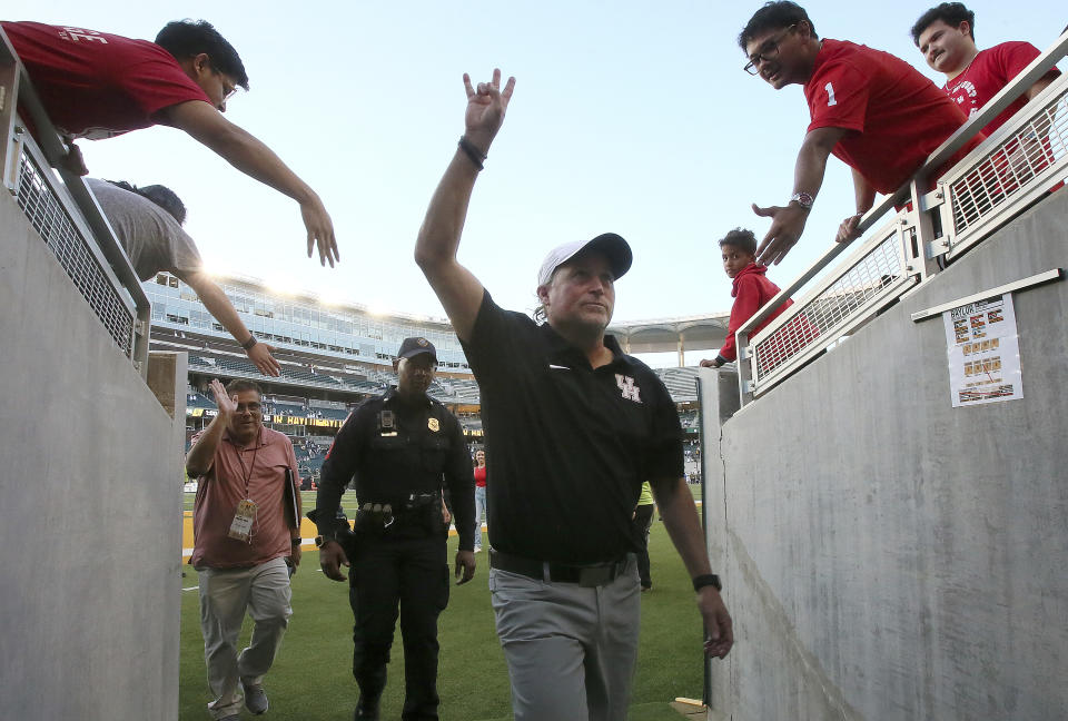 Houston head coach Dana Holgorsen gestures as he heads into the locker room after defeating Baylor in overtime after an NCAA college football game, Saturday, Nov. 4, 2023, in Waco, Texas. (Jerry Larson/Waco Tribune-Herald via AP)