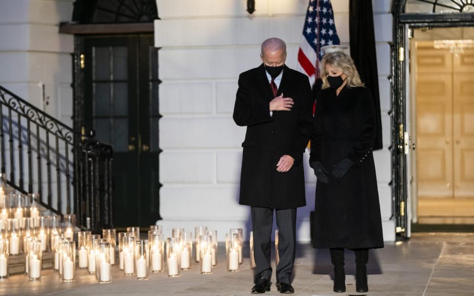 Joe Biden and the First Lady hold a moment of silence and candle lighting during a ceremony to honour lives lost to Covid-19 - EPA