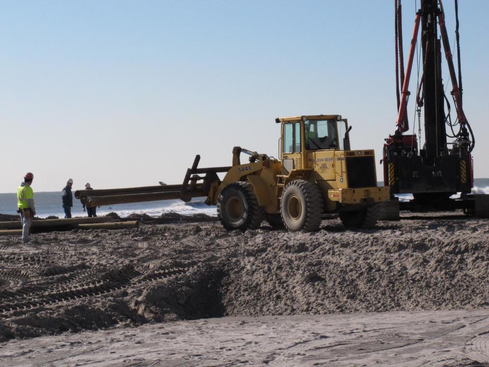 Workers move wooden pilings into place on the Atlantic City NJ beachfront on Wednesday, Nov. 14, 2012. It was the first day of construction on the $35 million Margaritaville entertainment complex at Resorts Casino Hotel. Construction crews started work on the Margaritaville project at Resorts Casino Hotel, in what casino president Gary Van Hettinga called a vote of confidence in the seaside resort's long-term viability. (AP Photo/Wayne Parry)