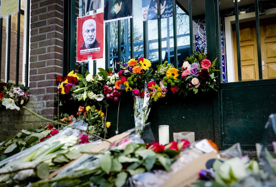 Flowers and posters are displayed at the gate of the Iranian embassy in the Hague on January 6, 2020 in memory of the recently killed Iranian general Qassem Soleimani. - Iranian top military commander Qasem Soleimani was killed on January 3 in a US air strike outside Baghdad international airport that shocked the Islamic republic and sparked fears of a new war in the Middle East. (Photo by Sem VAN DER WAL / ANP / AFP) / Netherlands OUT (Photo by SEM VAN DER WAL/ANP/AFP via Getty Images)