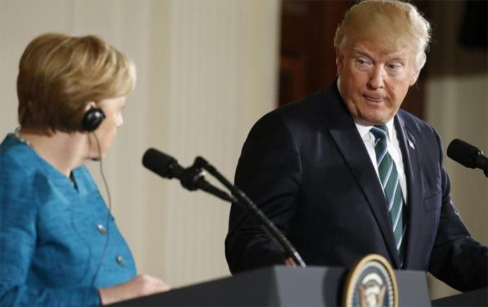 Trump holds a press conference with Merkel. Image: Reuters