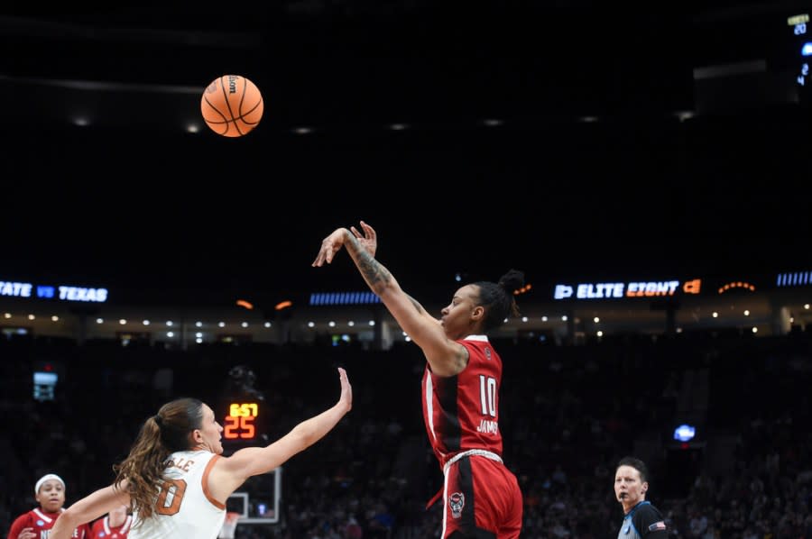 North Carolina State guard Aziaha James (1) shoots as Texas guard Shay Holle defends during the first half of an Elite Eight college basketball game in the women’s NCAA Tournament, Sunday, March 31, 2024, in Portland, Ore. (AP Photo/Steve Dykes)