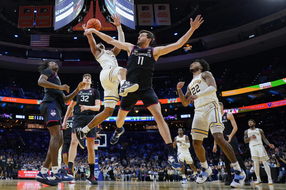 Villanova's Mark Armstrong, left, tries to get a shot past UConn's Alex Karaban during the second half of an NCAA college basketball game, Saturday, March 4, 2023, in Philadelphia. (AP Photo/Matt Slocum)