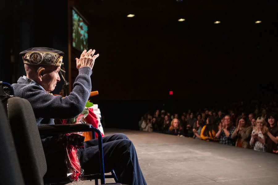 Pearl Harbor survivor Dick Higgins waves to a crowd of students and community members as he is introduced at a ceremony Dec. 7, 2023, at Bend High School in Bend, Ore., to honor him as well as those who died in the Dec. 7, 1941 attack on Pearl Harbor. Higgins, one of the few remaining survivors of the Japanese attack on Pearl Harbor, died Tuesday, March 19, 2024, at his home in Bend, Ore. He was 102. (Joe Kline/The Bulletin via AP)