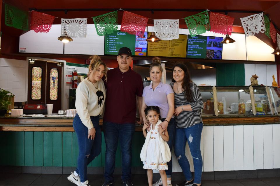 Luz Concileon, in the purple top, stands for a photo with her children Magnolia, Juan, Esther and Samantha (left to right). Concileon opened Taqueria Jalisco Antojitos Mexicanos to give her sons a business of their own one day.