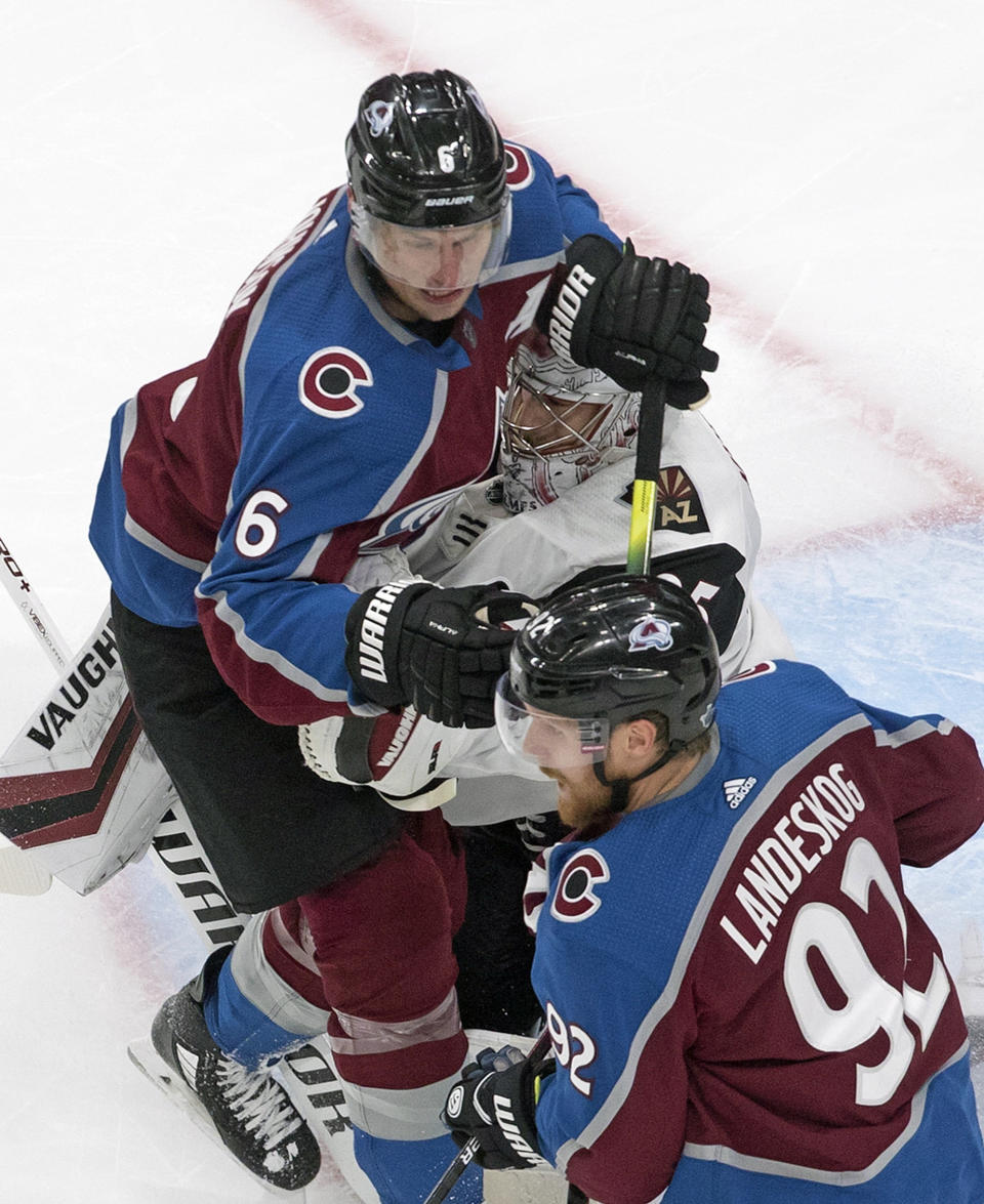 Arizona Coyotes goalie Darcy Kuemper (35) is crashed into by Colorado Avalanche's Erik Johnson (6) during the third period of an NHL hockey Stanley Cup first-round playoff series, Wednesday, Aug. 12, 2020, in Edmonton, Alberta. (Jason Franson/The Canadian Press via AP)