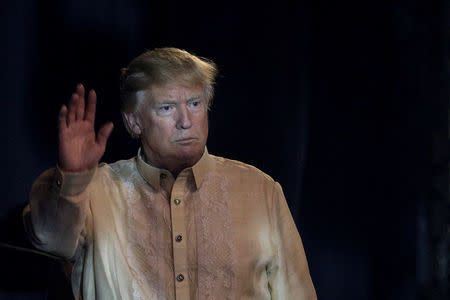 U.S. President Donald Trump waves as he arrives during the gala dinner marking ASEAN's 50th anniversary in Manila, Philippines, November 12, 2017. REUTERS/Athit Perawongmetha