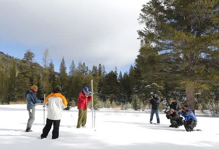 Frank Gehrke, (in red jacket) takes a snowpack measurement during the first snow survey of winter conducted by the California Department of Water Resources in Phillips, California, December 30, 2015. REUTERS/Fred Greaves