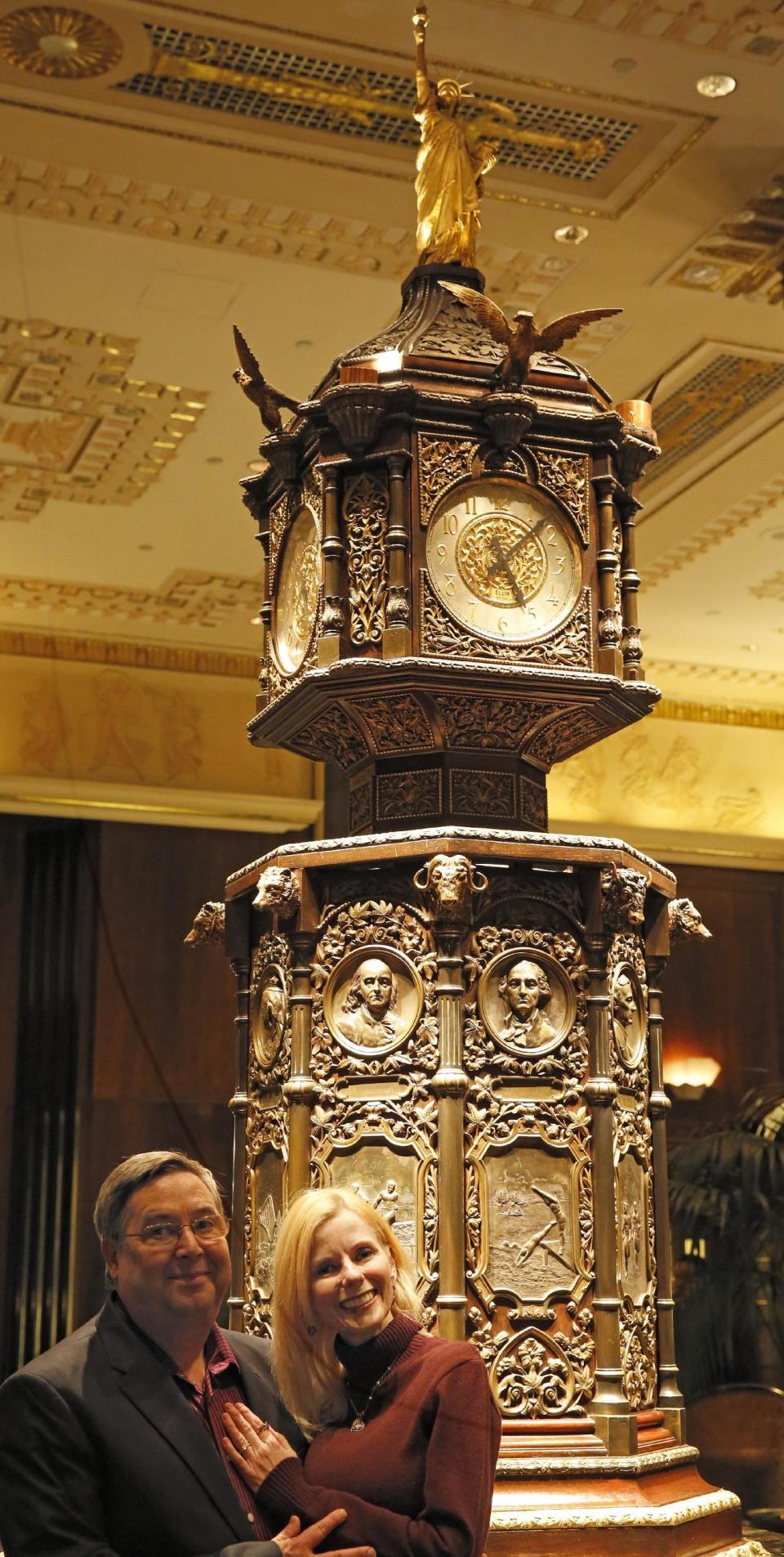 Martin Murphy and Rebecca Ward of Orlando, Fla., pose for a photograph beside the historic clock inside the renowned Waldorf Astoria hotel, Tuesday, Feb. 28, 2017, in New York. Two hotel regulars, Ward, 50, and her fiance, Murphy, 51, returned for two days this week to celebrate their engagement. Murphy proposed to Ward in front of the hotel's giant lobby clock one month ago. (AP Photo/Kathy Willens)