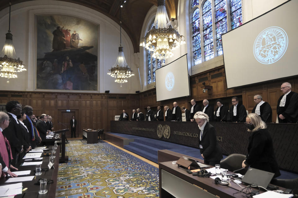 Judges and parties stand at the opening of the hearings at the International Court of Justice in The Hague, Netherlands, Thursday, Jan. 11, 2024. The United Nations' top court opens hearings Thursday into South Africa's allegation that Israel's war with Hamas amounts to genocide against Palestinians, a claim that Israel strongly denies. (AP Photo/Patrick Post)