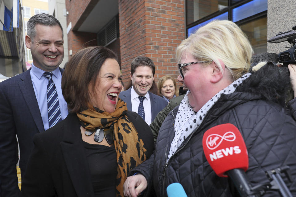 Sinn Fein leader Mary Lou McDonald, center, and Pearse Doherty, left, speak to members of the public during a campaign walkabout in central Dublin, Thursday Feb. 6, 2020. (Brian Lawless/PA via AP)