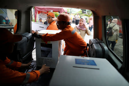 Workers prepare to distribute election materials to polling stations from a sports hall in Jakarta, Indonesia April 16, 2019. REUTERS/Edgar Su