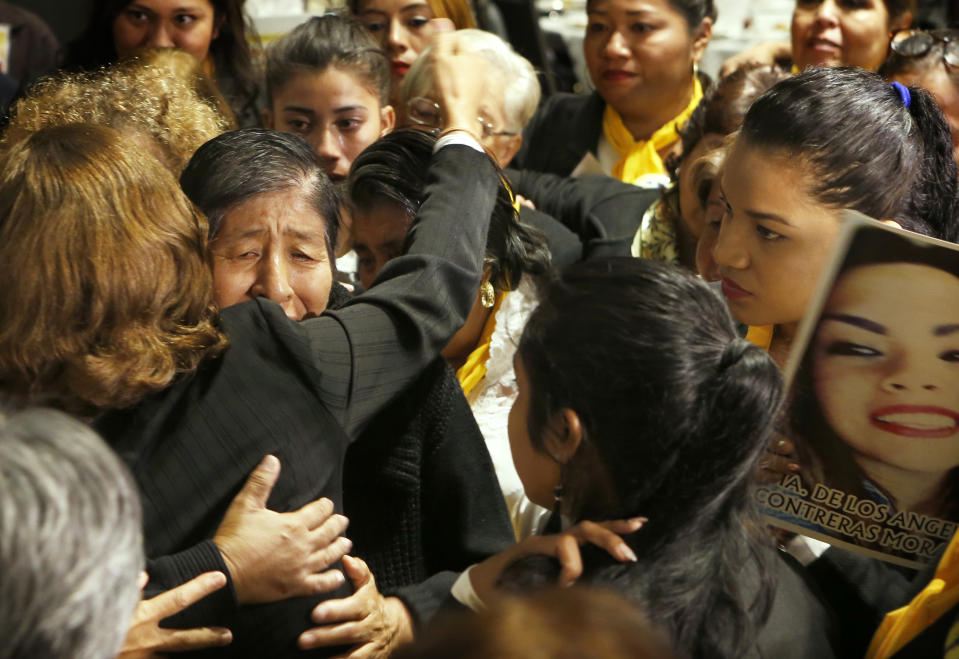 Women with missing relatives who form the volunteer group "Colectivo Solecito," or Little Sun Collective, hug and cry during an award ceremony in Mexico City, Tuesday, Oct. 16, 2018. The University of Notre Dame has presented its 2018 Notre Dame Award to the group of Mexican mothers who have led a tireless, years-long search for missing loved ones in Mexico's Gulf coast state of Veracruz. (AP Photo/Marco Ugarte)