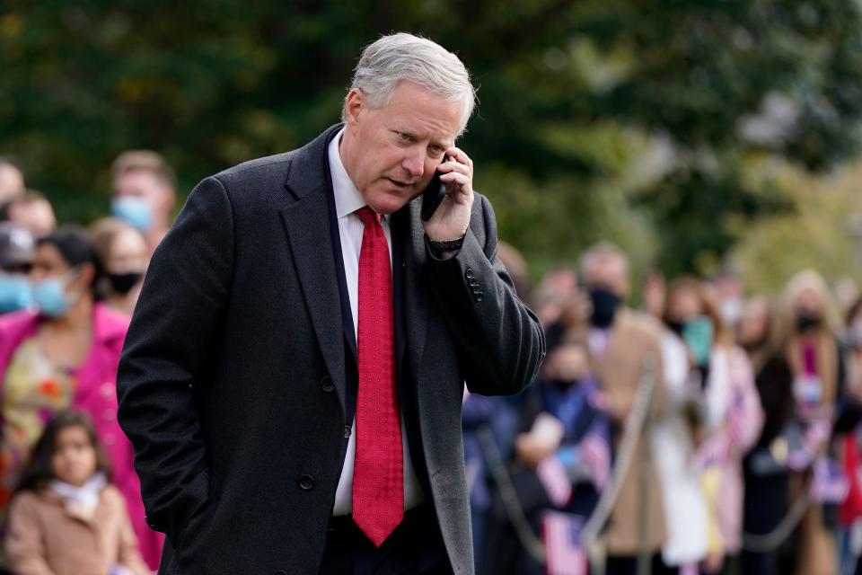 Then-White House chief of staff Mark Meadows speaks on a phone on the South Lawn of the White House on Oct. 30, 2020. The House committee investigating the Jan. 6 Capitol insurrection has issued almost three dozen subpoenas as it aggressively seeks information about the origins of the attack and what former President Donald Trump did — or didn’t do — to stop it.