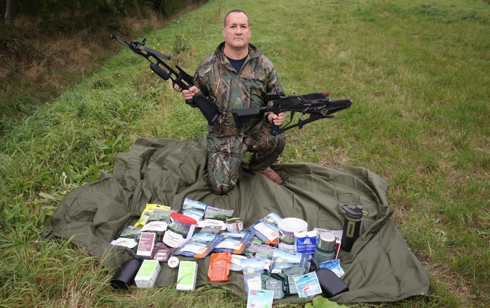 Prepper Justin Jones with some of the items he sells on his website - Phil Harris