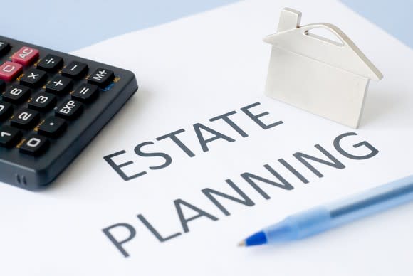 Estate planning document with a calculator and pen.