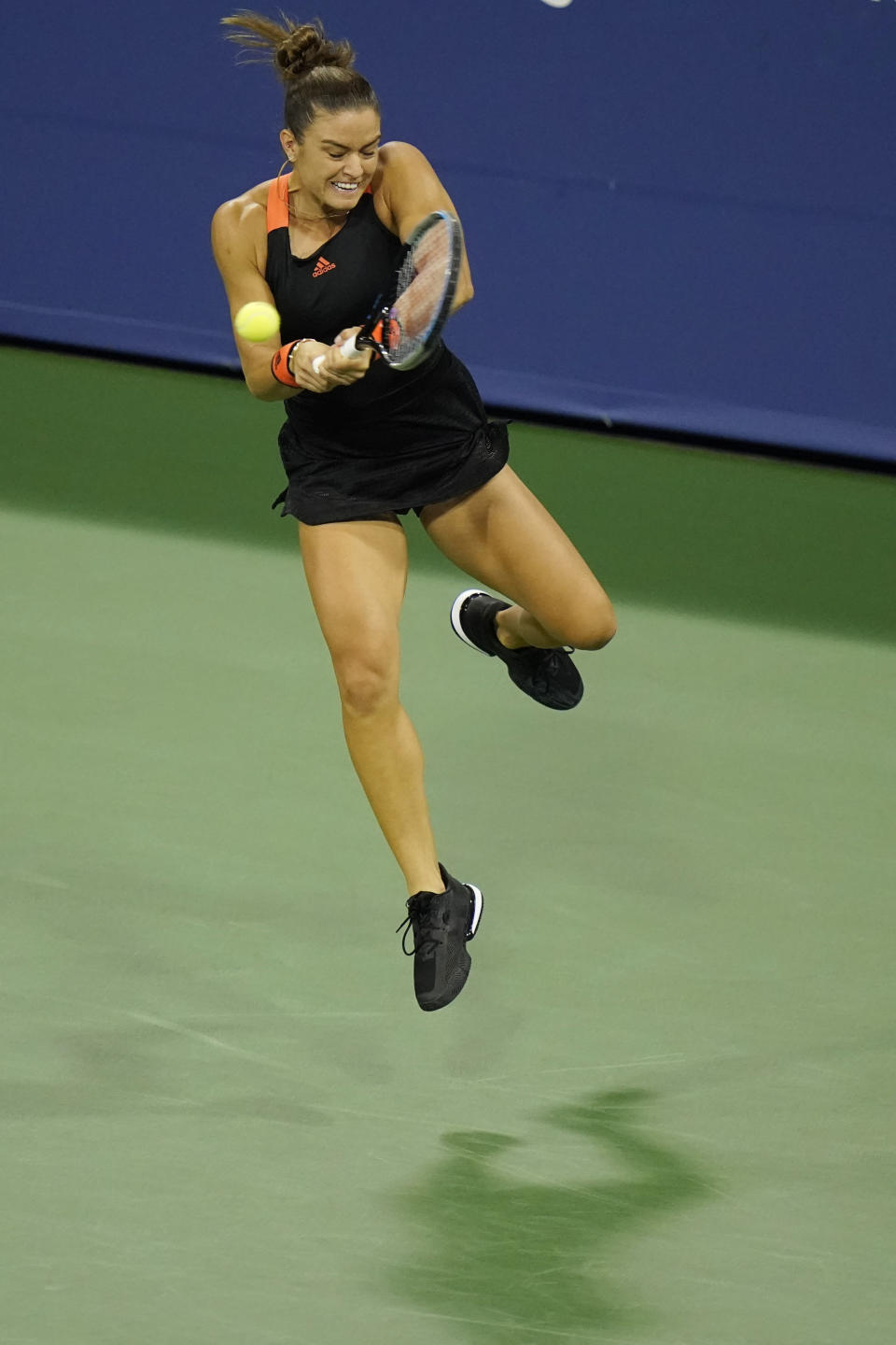 Maria Sakkari, of Greece, leaps high to return a shot to Serena Williams during the third round at the Western & Southern Open tennis tournament Tuesday, Aug. 25, 2020, in New York. (AP Photo/Frank Franklin II)