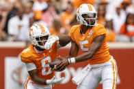 Tennessee quarterback Hendon Hooker (5) hands the ball off to running back Tiyon Evans (8) during the first half of an NCAA college football game against Tennessee Tech, Saturday, Sept. 18, 2021, in Knoxville, Tenn. (AP Photo/Wade Payne)