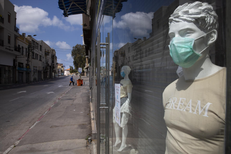 A face mask on a mannequin advertises them for sale, amid concerns over the country's coronavirus outbreak, on Israel's 72nd Independence Day, in Tel Aviv, Israel, Wednesday, April 29, 2020. Israel government announced a complete lockdown over the Independence Day to control the country's coronavirus outbreak. (AP Photo/Oded Balilty)
