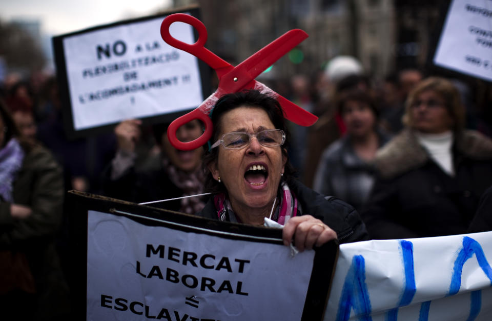 A woman shouts slogans against the government's recently approved labor reforms during a demonstration in Barcelona, Spain, Friday Feb. 19, 2012. Marches organized by the country's main trade unions are taking place throughout Spain. (AP Photo/Emilio Morenatti)