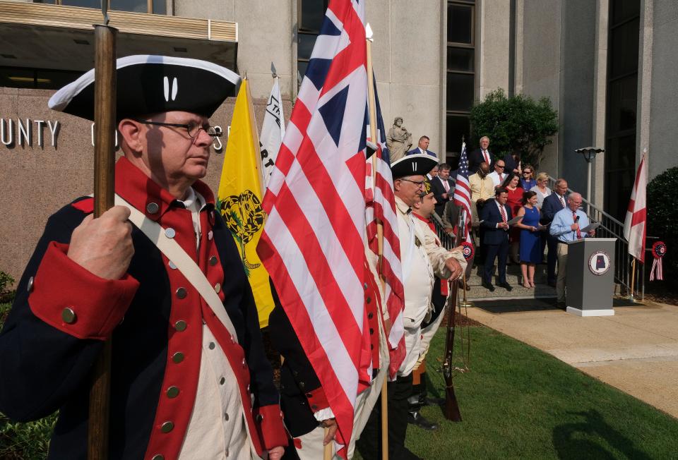 Members of the Tuscaloosa County Bar Association read the Declaration of Independence on the steps of the Tuscaloosa County Courthouse on June 30, 2023. The annual reading marks the Fourth of July Independence Day celebration. Members the Sons of the American Revolution color guard stand by as Circuit Judge Jim Roberts reads a section of the declaration.