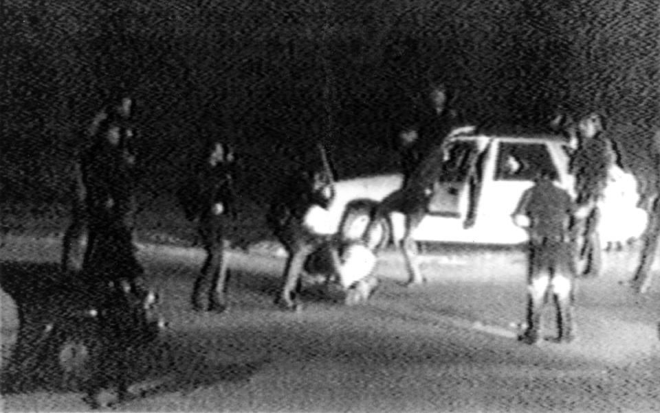 This March 31, 1991 frame from a video tape shot by George Holliday from his apartment in a suburb of Los Angeles shows what appears to be a group of police officers beating a man with nightsticks and kicking him as other officers look on. The April 29, 1992 acquittal of four police officers in the beating sparked rioting that spread across the city and into neighboring suburbs. Cars were demolished and homes and businesses were burned. Before order was restored, 55 people were dead, 2,300 injured and more than 1,500 buildings were damaged or destroyed. (AP Photo/George Holliday/Courtesy of KTLA Los Angeles)