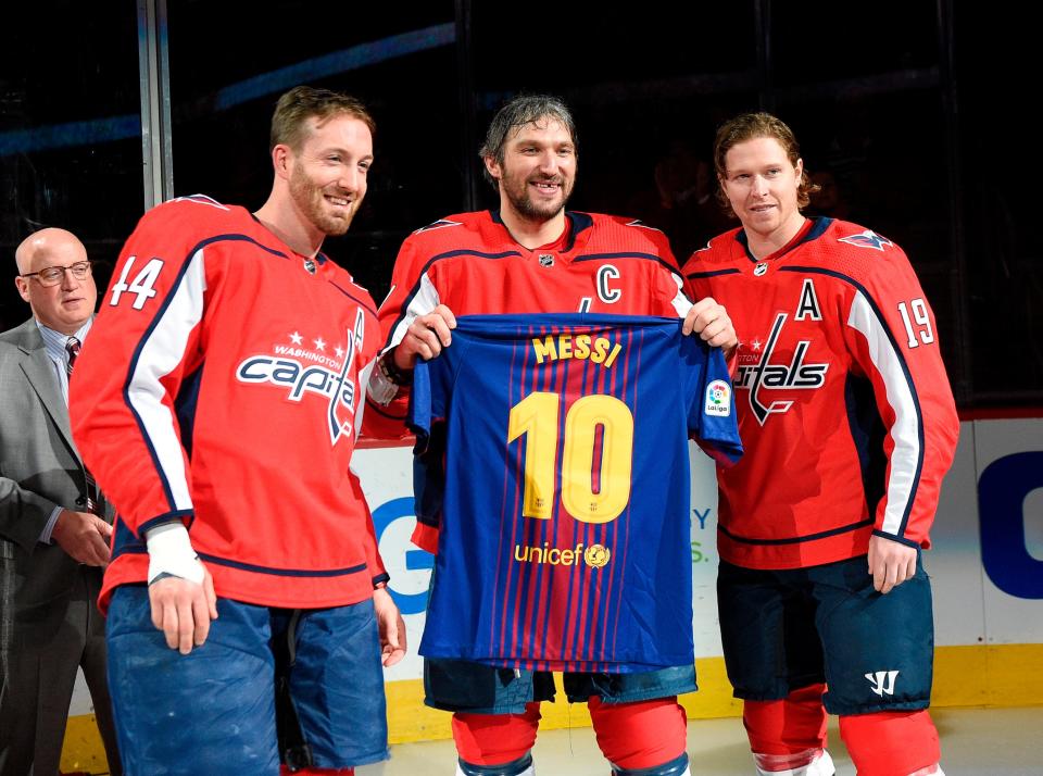 Washington Capitals left wing Alex Ovechkin, center, of Russia, poses with a Messi soccer jersey with Nicklas Backstrom (19), of Sweden, and Brooks Orpik (44) in 2018.