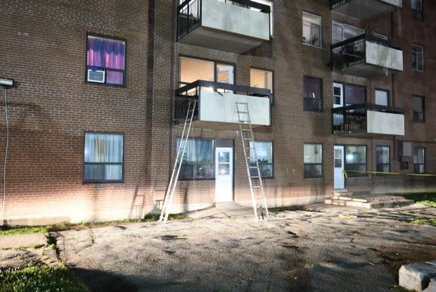 Ladders used by police can be seen propped against the balcony of Choudry and his family's apartment in Mississauga on June 20, 2020.