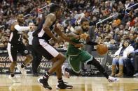 Dec 12, 2018; Washington, DC, USA; Boston Celtics guard Kyrie Irving (11) dribbles the ball as Washington Wizards center Thomas Bryant (13) defends in the fourth quarter at Capital One Arena. The Celtics won 130-125 in overtime. Mandatory Credit: Geoff Burke-USA TODAY Sports