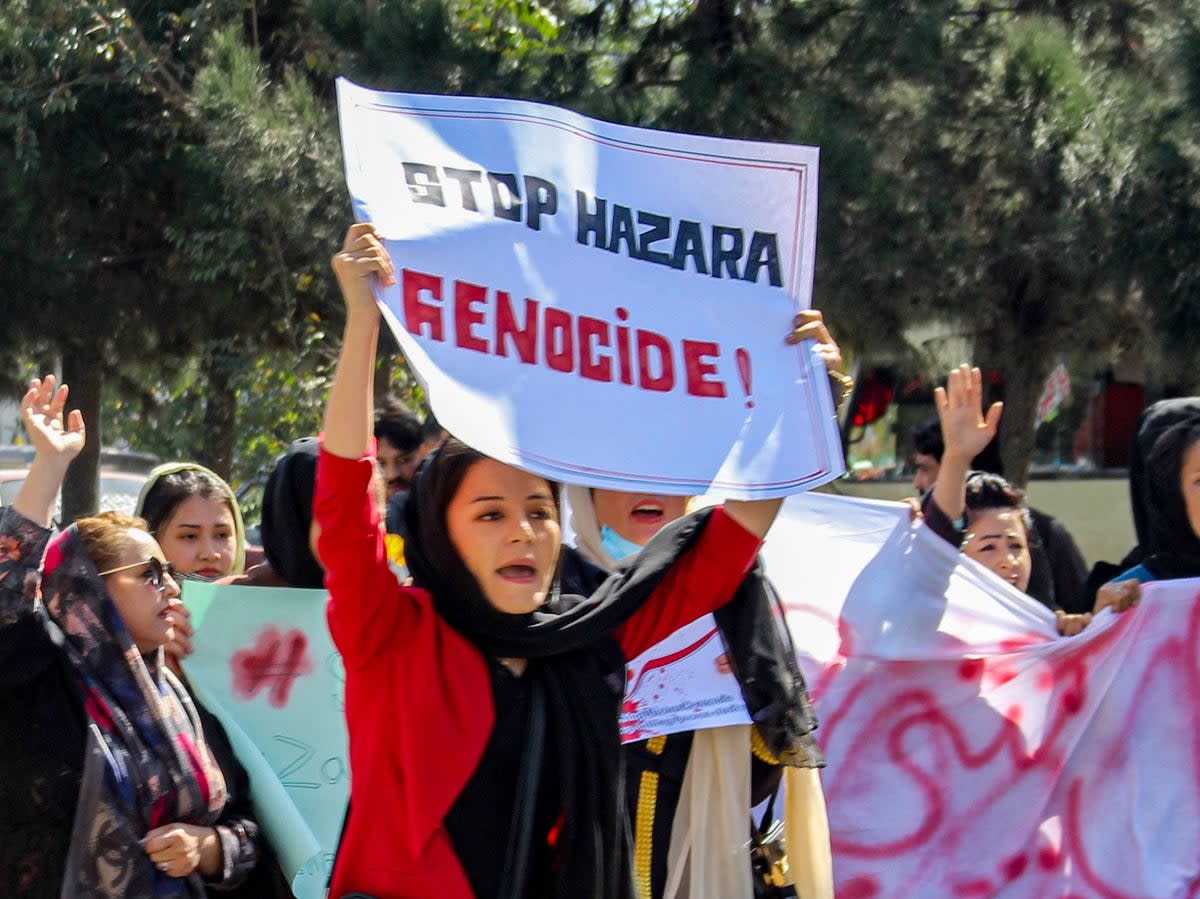 Afghan women display placards and chant slogans during a protest they call Stop Hazara genocide a day after a suicide bomb attack at Dasht-e-Barchi learning centre, in Kabul on October 1, 2022 (AFP via Getty Images)