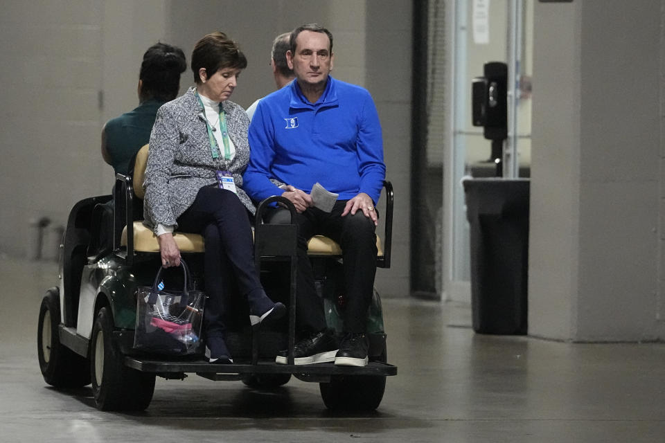 Duke head coach Mike Krzyzewski leaves a news conference with his wife, Mickie, after a loss to North Carolina in a college basketball game during the semifinal round of the Men's Final Four NCAA tournament, Saturday, April 2, 2022, in New Orleans. (AP Photo/David J. Phillip)