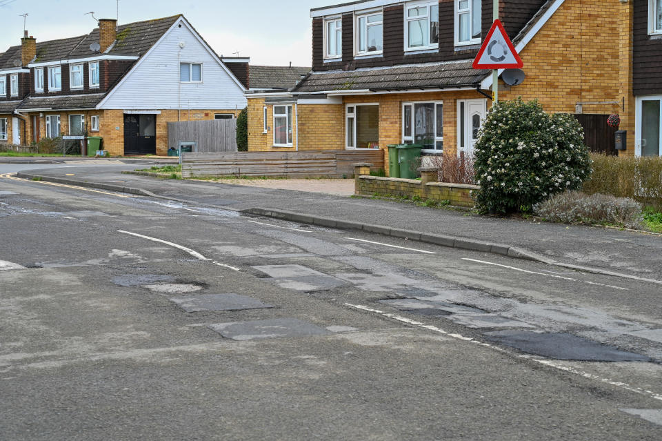 Residents of Caernarvon Road in Cheltenham are furious at council after certain roads are repaved but this one. February 23 2024. See SWNS story SWLNpothole. Residents are baffled after the council could 'only afford' to repair a tiny 230m stretch of their pothole-filled road - leaving most of it full of holes. This week workers visited Caernarvon Road in Cheltenham, Gloucestershire, after weeks of complaints from residents over the state of the road. But they only filled in huge potholes on a small stretch - leaving the remaining 500m filled with 50cm potholes. Residents claim the council told they they only had enough cash in the kitty to fill in the tiny stretch.