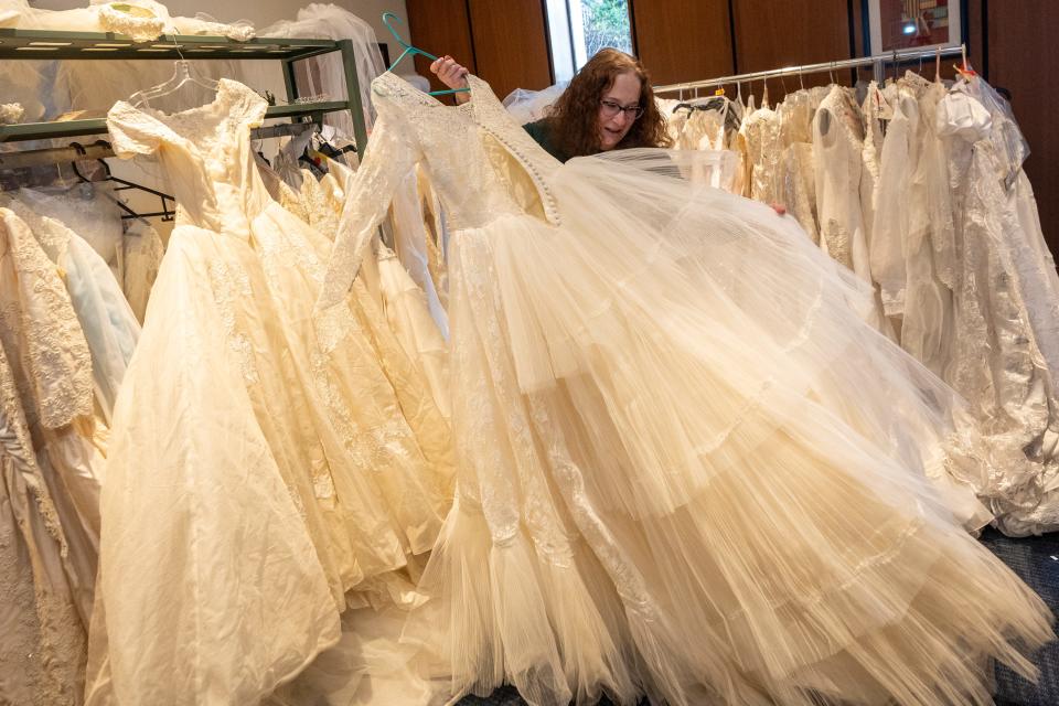 Apr 4, 2024; Fair Lawn, NJ, United States; The Maurice M. Pine Free Public Library has a lending library of wedding dresses. Library Director Adele Puccio shows off one of the wedding gowns.