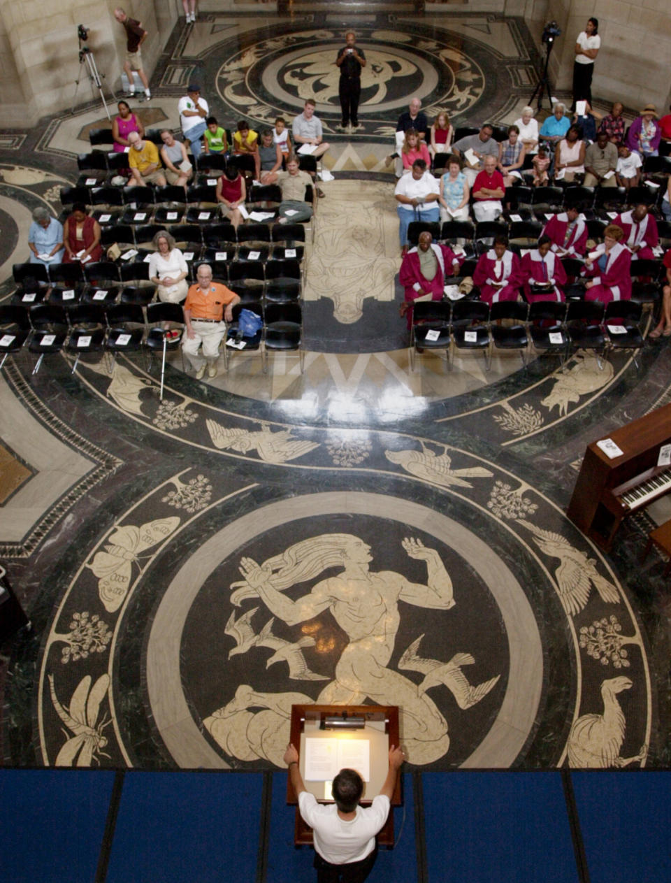 FILE - This Aug. 23, 2003 file photo shows Nebraska Gov. Mike Johanns, bottom, addresses a gathering in the rotunda of the State Capitol in Lincoln featuring the floor decorated with the design of Art Deco muralist Hildreth Meiere. While Meiere's name has been largely forgotten her works abound throughout the country. “The Art Deco Murals of Hildreth Meiere,” by Catherine Coleman Brawer and Kathleen Murphy Skolnik with photographs by Meiere’s granddaughter, Hildreth Meiere Dunn, is set for release May 1. (AP Photo/Nati Harnik, File)