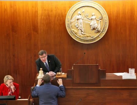 Speaker of the North Carolina House of Representatives Tim Moore (C) confers with a colleague as the chamber convenes to consider repealing the controversial HB2 law limiting bathroom access for transgender people in Raleigh, North Carolina, U.S. on December 21, 2016. REUTERS/Jonathan Drake