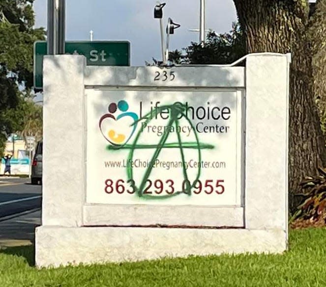 The symbol for anarchy covers the roadside sign at LifeChoice Pregnancy Center in Winter Haven. The management said graffiti was spray-painted onto and around the building over the weekend following Friday's Supreme Court ruling nullifying nationwide abortion rights.